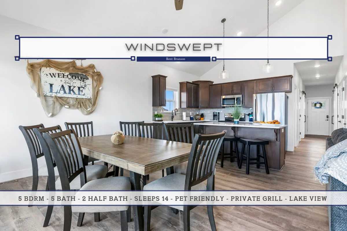 Featuring a generous dining table set for a gathering, the image provides a direct view into the adjacent kitchen area. Warm lighting and a welcome sign enhance the inviting, festive feel of the communal hub.